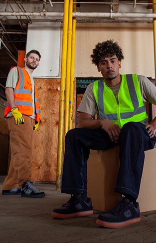 two men wearing DC footwear in construction environment